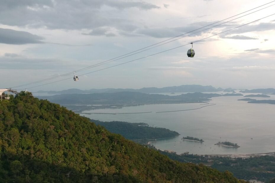 Breathtaking aerial view of Langkawi's cable car with lush forests and serene coastline.